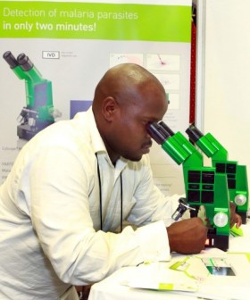 Looking for malaria parasite: Medical Technologist and Customer Service Director of PARTEC Alex Lope  demonstrates through a microscope the rapid detection of malaria and  diagnosis during the 6th MIM Pan-African Malaria Conference held at the International Convention Centre in Durban on October 8, 2013.