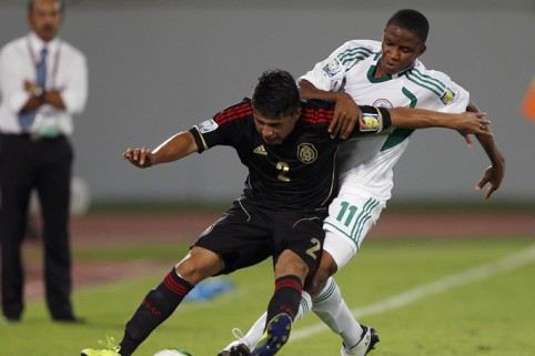 A Nigerian Eaglet (right) struggles for the ball
