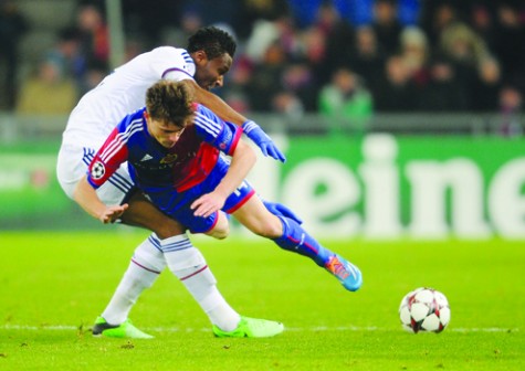 COLLISON...Basels Swiss midfielder Valentin Stocker (right) collides with Chelseas Nigerian midfielder John Mikel Obi during their UEFA Champions League group E match at St Jakob Park in Basel yesterday. Chelsea lost 0-1. Inset is Chelsea coach, Jose Mourinho. AFP PHOTO.