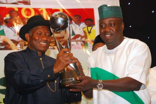 File photo: ex Sports minister, Bolaji Abdullahi presenting  the FIFA World  cup to President Jonathan