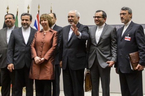 EU foreign policy chief Catherine Ashton (3rd L) poses next to Iranian Foreign Minister Mohammad Javad Zarif and the Iranian delegation after a statement on early November 24