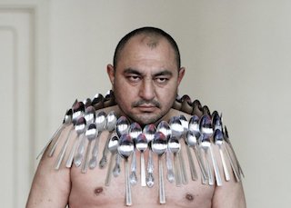 Etibar Elyichev posing with 50 spoons in 2011