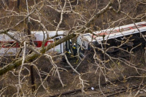  National Transportation Board (NTSB) workers look over the wreckage after a Metro-North commuter train derailed just north of the Spuyten Duyvil station December 1, 2013 in the Bronx borough of New York City. 