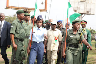 Governor Adams Oshiomhole inspects a parade of armed forces personnel
