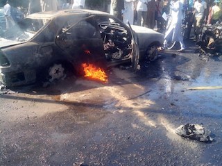 File Photo: A burning car at Maiduguri market after a bomb blast.