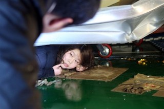 One of the students lies trapped in the debris of the building