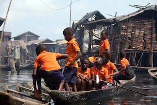 School kids traveled by canoe after closing hour in the floating slum