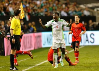 Emenike earns a yellow card as he reacts towards Assistant Referee Peter Manikowski at Georgia Dome on March 5, 2014