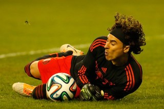 Mexican keeper Ochoa makes a goal bound save