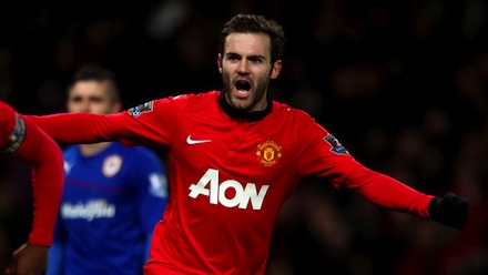 Juan Mata of Manchester United celebrates Robin van Persie scoring their first goal during the Barcl