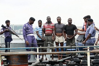 Suspected pirates are paraded aboard a naval ship after their arrest by the Nigerian Navy at a defence jetty in Lagos