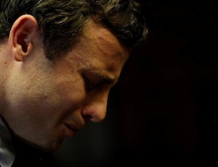 Olympic and Paralympic running star Oscar Pistorius reacts ahead of court proceedings at the Pretoria Magistrates court