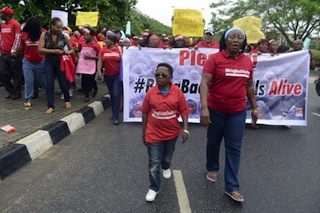 Nollywood celebrities Chinedu Ikedieze (L) , aka Aki and Patience Ozokwor, aka Mama G, march for the release of the more than 200 abducted Chibok school girls
