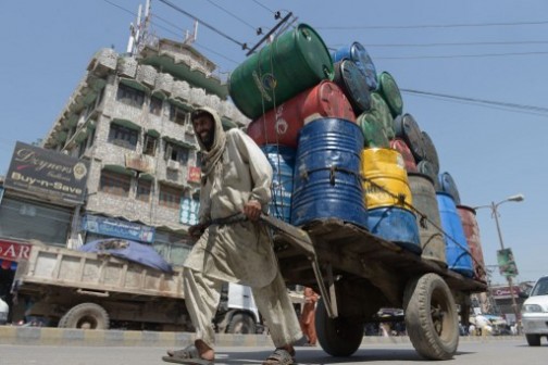 A Pakistani labourer pulls his cart loaded with barrels in Rawalpindi on May 27. May God lessen his burden!