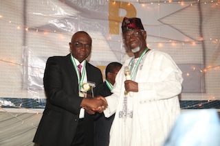 Mr Bayo Onanuga (Left) receiving his award from Engr. Bosun Oke