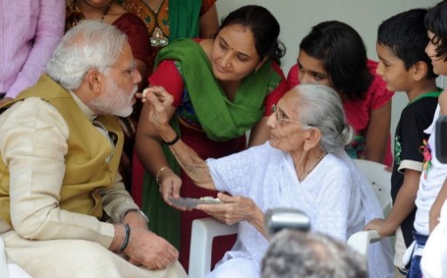 Modi being fed sweet by his mother