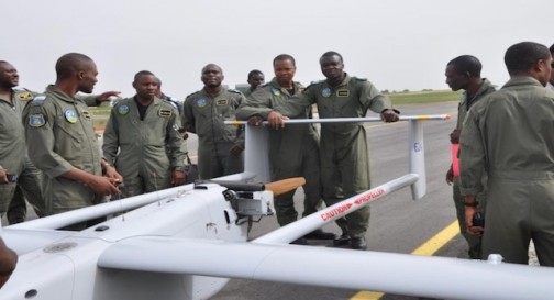 Nigeria's Air Force personnel pose next to a Aerostar drone