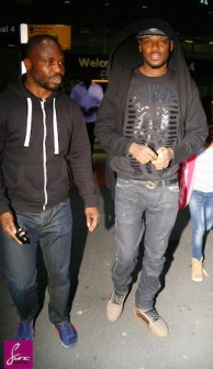 Tu Face Idibia, right, on arrival in London 2 May. Sync Photo