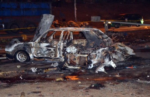 a charred car at Nyanya Thursday night. AFP