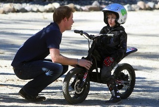 Prince Harry chats with a boy during a visit to the Antaeaya outdoor centre