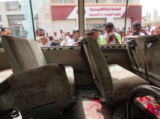 Yemenis look at the inside of an army minibus that was attacked by a gunman with an assault rifle