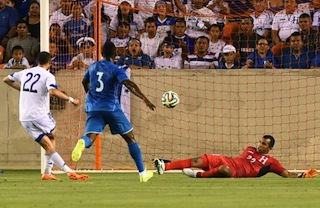 Israel's Omar Damari (L) kicks the ball past Honduras goalkeeper 