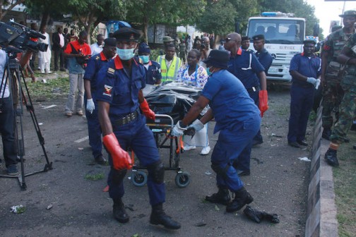 A dead victim being carried away by emergency workers