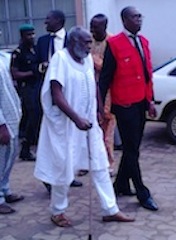 One of the defendants, Mohammed Rabiu Lawan (alias Shande Dzungwe Ako) being led away by an EFCC official in court in Lagos on Monday.