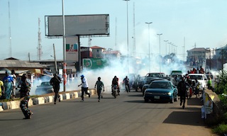 APC members and passersby scampering for safety from rampaging policemen at the scene of the attack in Ijigbo area, Ado-Ekiti on 8 June 2014