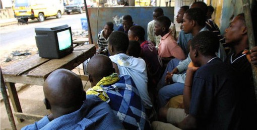 Nigerian youths watch TV in Lagos