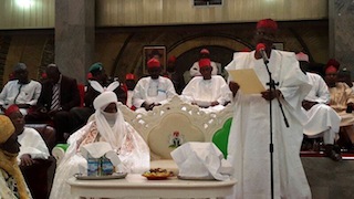 Governor Rabi'u Musa Kwankwaso of Kano state reading the of appointment to the hearing of the public before formally presenting it to the new Emir of Kano, His Highnes Sanusi Lamido Sanusi at Africa House, Government House, Kano