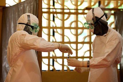 Dr. Brantly, right, collects blood sample