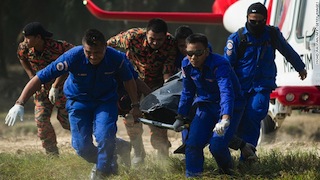 File Photo: Rescue team carries a victim's body after a boat capsizes in Malaysia