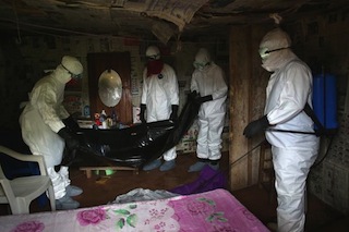 Health workers clear out the apartment of a 48-year old British Nigerian woman feared to have died of the deadly Ebola virus in Austria