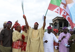 Peoples Democratic Party's Legal Adviser in Osun State, Barrister John Abolarinwa Abidoye (middle); Acting Chairman of Alliance for Progressive Congress (APC), Elder Adelowo Adebiyi (4th right); Chief of Staff to Osun Governor, Mr. Gboyega Oyetola (left); APC Assistent Public Relation Officer, Apostel Samson Oyebode (2nd right); Secretary of APPC, Prince Gboyega Famodun (right).With them are Abidoye's wife, Kemi (2nd left); Shade and Lola (4th right), during the defection of the PDP Legal Adviser to APC, held at the Party Secretariat, Osogbo on Tuesday 26/08/2014