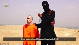 File Photo: A Briton and IS Jihadist brandishes a knife with which he beheads American journalist James Foley