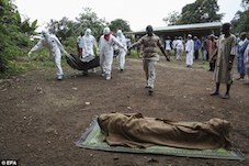 File Photo: Medics carry an Ebola victim in Liberia