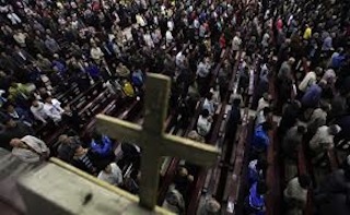 Worshippers praying in church