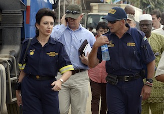Officials of South African Search and Rescue and Victims Identification Center arrive at the site