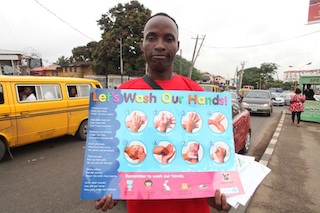 A Nigerian campaigning to rise awareness on Ebola virus in the street of  Lagos1
