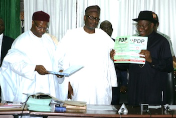 President Goodluck Jonathan displays his nomination form which cost N22 million. With him are the national chairman of PDP, Alhaji Mu'azu and national organising secretary, Alhaji Abubakar Mustapha