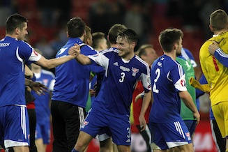 Faroe Island's players celebrate after winning the UEFA Euro 2016 group F qualifying football match against Greece