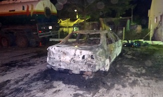 FILE: Carcass of a burnt car sits in Nagarshiku fuel station, scene of a suicide explosion in Kano