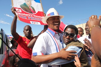 Namibian opposition party Democratic Turnhalle Alliance presidential candidate McHenry Venaani(C) is greeted by supporters