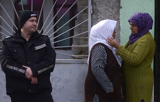 A woman comforts the mother of Ahmed Musa Ahmed, local imam while police search her house in the Roma suburb of the city of Pazardjik