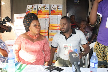 Nollywood actor turned politician, Desmond Elliot (R) listens as Kanu Nwankwo addresses widows in Surulere