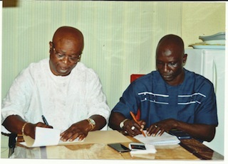 Chairman of Abia Warrior, Emeka Inyama, left, with Coach   Ladan Bosso sigining necessary papers for an extended deal for the   Bossoi