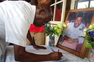 Governor Adams Oshiomhole signing the condolence register at the residence of the late lawmaker in Benin 