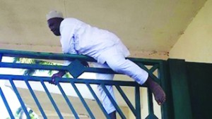 •Hon Cheche, from Niger State, scaling the gate to enter the National Assembly this morning