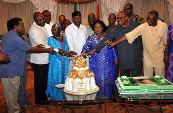 Party Time: President Goodluck Jonathan (C) is joined by others to cut his cake